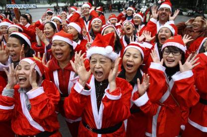 "Members of the "Laughter Yoga" club participate in an event called "Christmas Smile" near the Hoan Kiem Lake in Hanoi, Vietnam, on Dec. 23, 2012. (Xinhua/Ho Nhu Y)